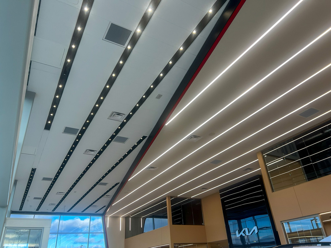 TechoLED BX-2 direct linear LED fixtures surface mounted with continuous run in Kia Showroom.