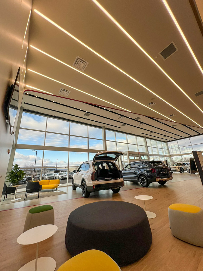 TechoLED BX-2 direct linear LED fixtures surface mounted with continuous run in Kia Showroom.