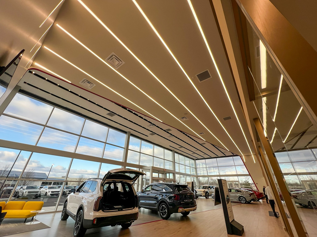 TechoLED BX-2 direct linear LED fixtures surface mounted with continuous run in Kia Showroom.