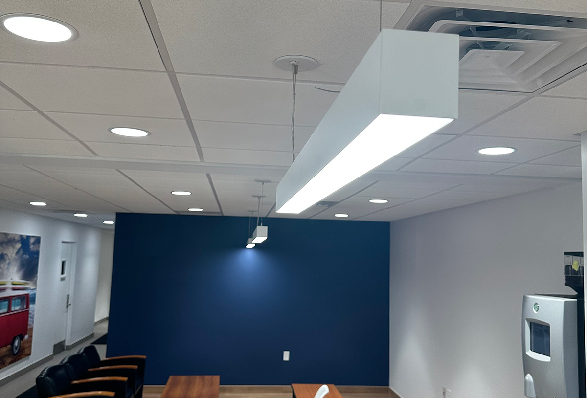 TechoLED BX-4 direct linear LED pendant fixture in modern office. White option.