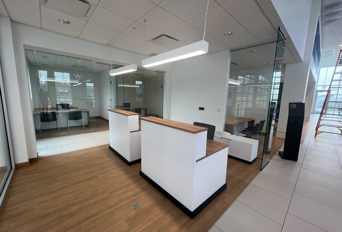 TechoLED BX-4 direct linear LED pendant fixture in modern office. White option.