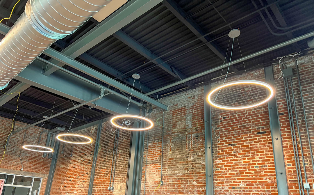 TechoLED Halo Direct Series pendant round LED luminaires in modern industrial office