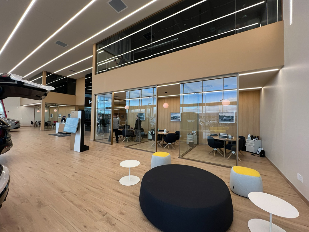 TechoLED BX-2 direct linear LED fixtures surface mounted with continuous run in Kia Showroom.